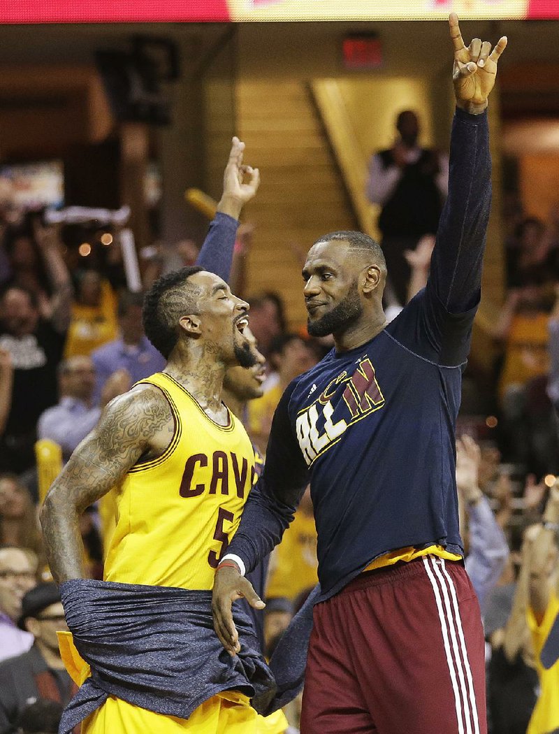 Cleveland’s J.R. Smith (5) and LeBron James celebrate Tuesday night in the fourth quarter of a 118-88 victory over Atlanta in the NBA Western Conference finals in Cleveland.