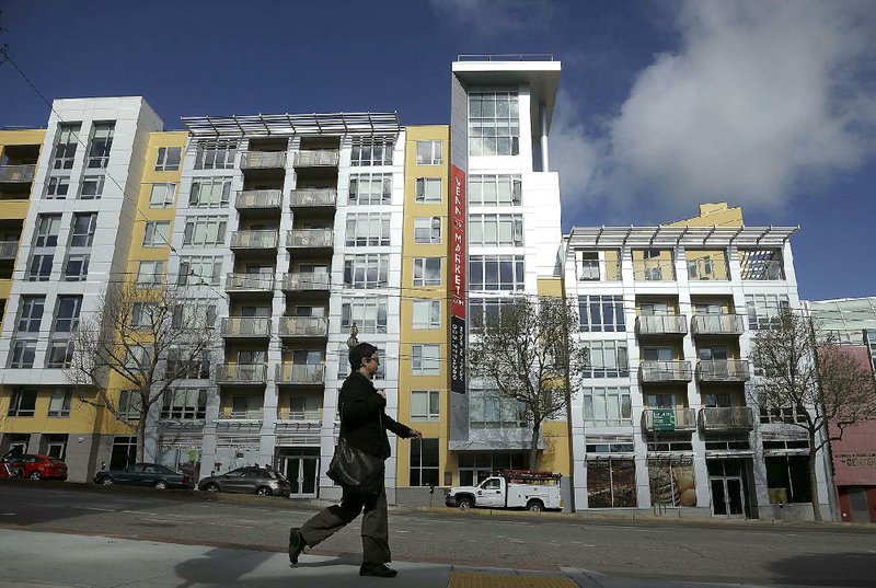 A woman crosses the street near the Venn on Market apartment and condominium building in San Francisco in March. New-home sales climbed 6.8 percent last month, the Commerce Department said Tuesday. 