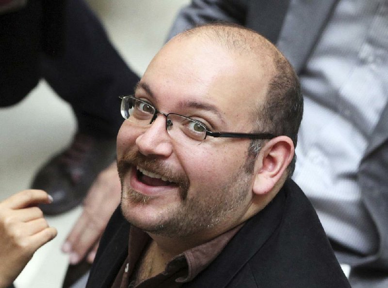  In this photo April 11, 2013 file photo, Jason Rezaian, an Iranian-American correspondent for the Washington Post, smiles as he attends a presidential campaign of President Hassan Rouhani, in Tehran, Iran. The closed trial of Rezaian detained in Iran for more than 10 months has begun in a court used to hear security cases.