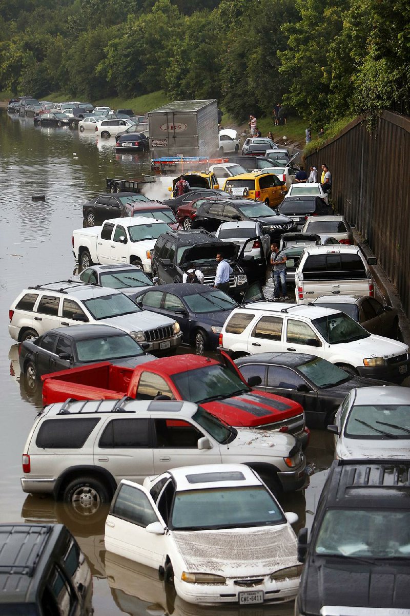 High water strands motorists Tuesday on Interstate 45 in Houston. Traffic was backed up for miles. 