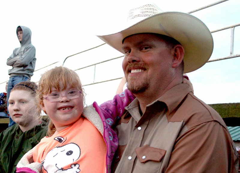 Landon Reeves/Herald Leader Jaiden Gunter and her father Joey are big fans of these cowboys. They attend every show they can between here and Tulsa, Joey said.