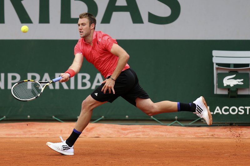 Jack Sock of the U.S. returns the ball to  Bulgaria's Grigor Dimitrov during their first round match of the French Open tennis tournament at the Roland Garros stadium, Tuesday, May 26, 2015 in Paris. 
