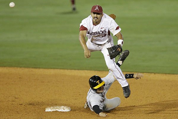 Arkansas second baseman Michael Bernal, top, throws to first after forcing out Tennessee's Jordan Rodgers at second base during the eighth inning of a Southeastern Conference college baseball tournament game Tuesday, May 19, 2015, in Hoover, Ala. (AP Photo/Brynn Anderson)