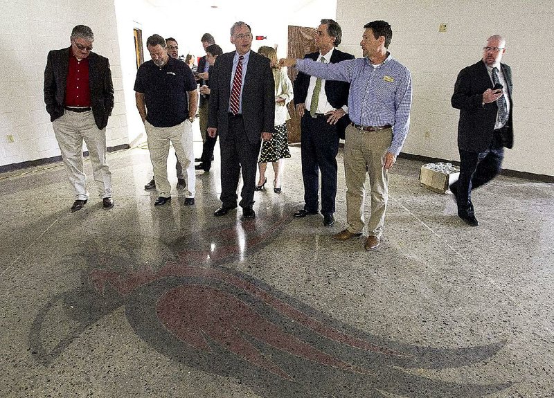 Vilonia School District Superintendent David Stephens (second from right) leads U.S. Rep. French Hill (third from right) and U.S. Sen. John Boozman (center) through the rebuilt Vilonia Intermediate School on Wednesday during a tour with Faulkner County officials. 