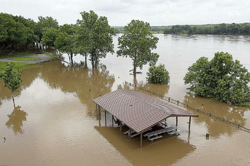 The Arkansas River encroaches on Toad Suck Park at Bigelow on Wednesday as the water level rises. Barge traffic was closed at the Toad Suck lock and dam and at Morrilton.