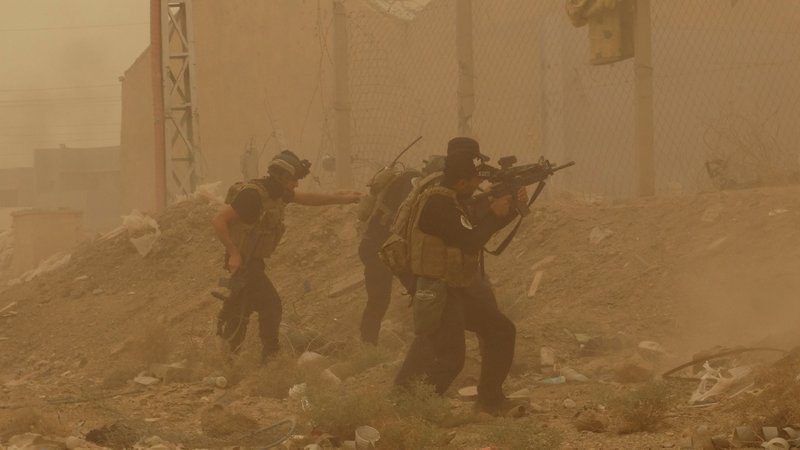  In this May 14, 2015 file photo, security forces defend their headquarters against attacks by Islamic State extremists during a sandstorm in the eastern part of Ramadi, the capital of Anbar province, Iraq. An Iraqi military spokesman said Wednesday, May 27, 2015, that Islamic State extremists used a sandstorm that engulfed most of Iraq on Tuesday night to unleash a wave of suicide attacks targeting the Iraqi army in western Anbar province, killing at least 17 troops in a major blow to government efforts to dislodge the militants from the sprawling Sunni heartland. 