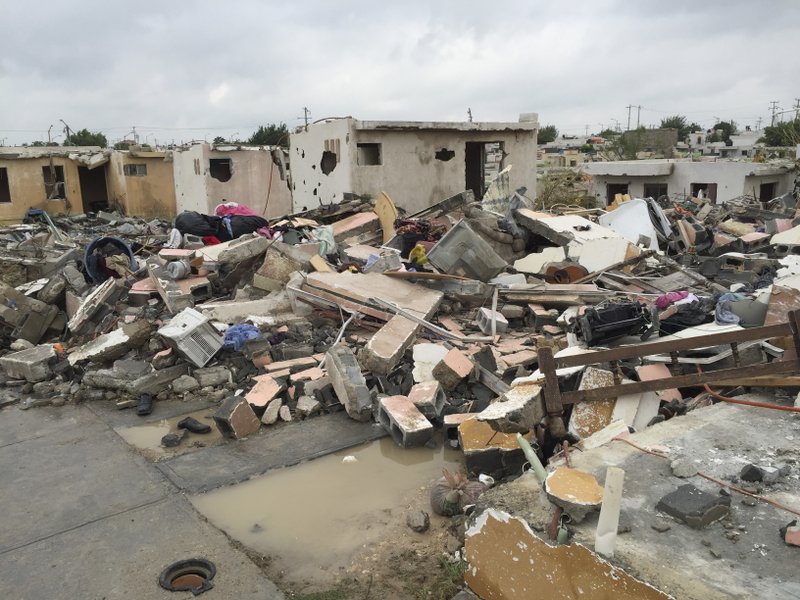 Damaged homes stand next to others that were razed when a powerful tornado touched down in Ciudad Acuna, northern Mexico, Monday, May 25, 2015. The tornado raged through the city on the U.S.-Mexico border Monday, destroying homes and flinging cars like matchsticks.