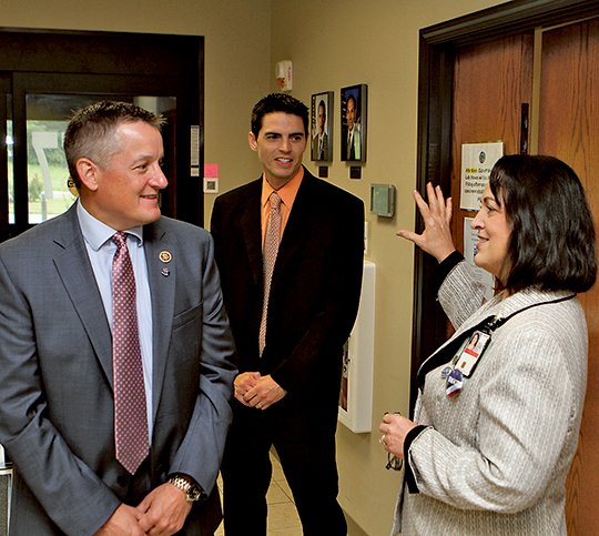 The Sentinel-Record/Richard Rasmussen CLINIC TOUR: U.S. Rep. Bruce Westerman, R-District 4, left, talks with Dr. Margie Scott, Central Arkansas Veterans Healthcare System’s interim director, right, on Wednesday as his Military and Veterans Affairs representative, David Witte, looks on during a tour of the Hot Springs Veterans Affairs Clinic.