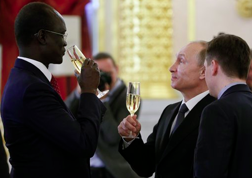 Russian President Vladimir Putin, second right, speaks with South Sudan's Ambassador Telar Ring Deng at a ceremony of presentation of credentials by foreign ambassadors in the Kremlin in Moscow, Russia, Thursday, May 28, 2015. President Vladimir Putin accused the United States of meddling in FIFA's affairs and hinted that it was part of an attempt to take the 2018 World Cup away from his country.