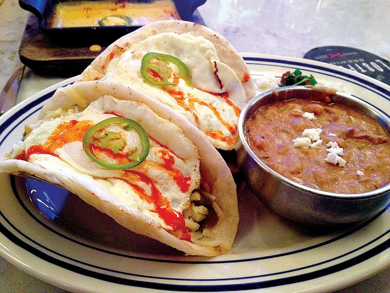 The All-Day Breakfast Tacos at Heights Taco & Tamale Co. feature fried egg, house-made chorizo sausage, Hatch green chile salsa, Jack cheese and Cholula mild sauce.