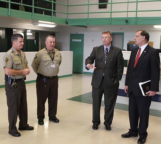 The Sentinel-Record/Richard Rasmussen NEW APPROACH: U.S. Sen. John Boozman, R-Ark., right, listens Thursday as Garland County Sheriff Mike McCormick, second from right, explains the direct supervision concept deputies will practice at the new Garland County Detention Center. Chief Deputy of Corrections Mark Chamberlain, left, and Capt. Ronnie Branstetter, director of security, helped conduct the tour.