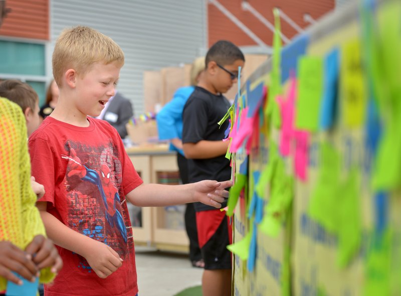 NWA Democrat-Gazette/BEN GOFF River Hall, 6, a kindergartener, places his signed sticky note on the &#8216;Declaration of Innovation&#8217; between the Scott Family Amazeum and Bentonville Public Schools at Willowbrook Elementary in Bentonville. Leadership Benton County also presented a tinkering cart they built for Leah Cheek&#8217;s second-grade class, complete with tools and supplies for creative hands-on learning. For photo galleries, go to nwadg.com/photos.