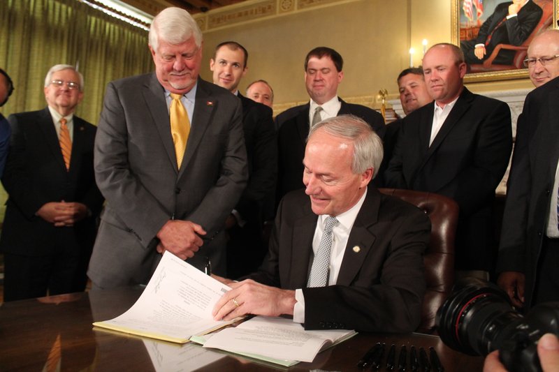 Gov. Asa Hutchinson signed into law on Friday, May 29, 2015, two bills to issue $87.1 million in state bonds to help Lockheed Martin win a defense contract to build joint light tactical vehicles for the military. 