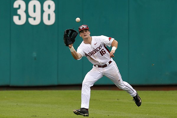 Arkansas outfielder Andrew Benintendi reaches up to grab a fly out by Oral Roberts's Anthony Sequeira in the third inning of a game at the Stillwater Regional of the NCAA college baseball tournament in Stillwater, Okla., Friday, May 29, 2015. (AP Photo/Sue Ogrocki)