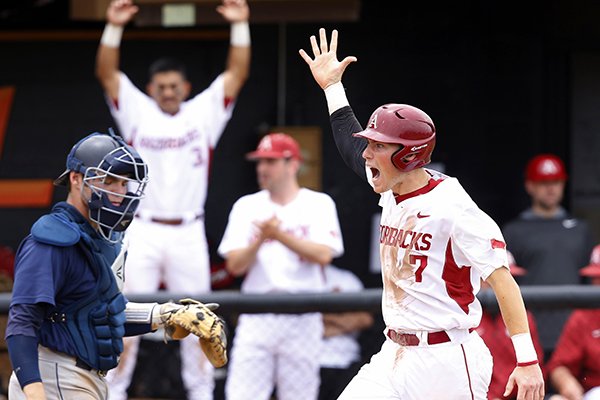 Arkansas' Bobby Wernes (7) celebrates as he crosses the plate in front of Oral Roberts catcher Matt Whatley, left, as Wernes scored on a double by Andrew Benintendi that also scored Joe Serrano in the sixth inning of a game at the Stillwater Regional of the NCAA college baseball tournament in Stillwater, Okla., Friday, May 29, 2015. Arkansas won 8-6. (AP Photo/Sue Ogrocki)