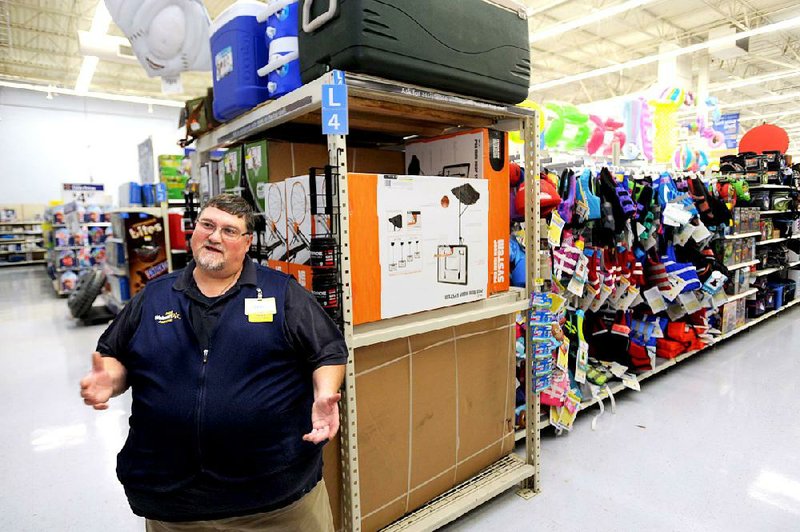 Gary Kealy, a sporting goods employee at Wal-Mart, is one of the company’s 500,000 employees who recently got a pay raise. He said he is using the money to expand his deck. 