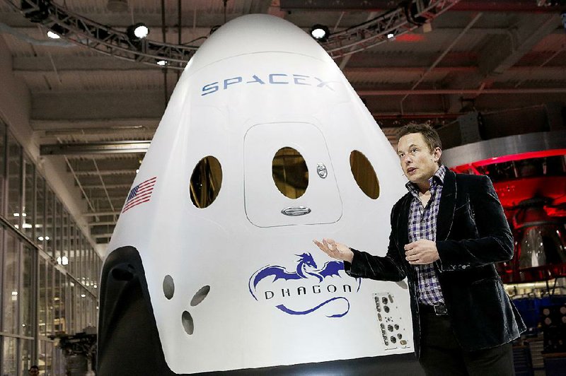 Elon Musk, chief executive officer of Space Exploration Technologies Corp., or SpaceX, unveils the Manned Dragon V2 Space Taxi in Hawthorne, Calif., in May 2014.