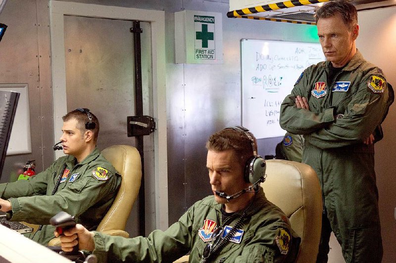 Zimmer (Jake Abel), Maj. Tom Egan (Ethan Hawke) and Lt. Col. Jack Johns (Bruce Greenwood) fly lethal drone missions from the safety of a trailer outside Las Vegas in Andrew Niccol’s Good Kill.
