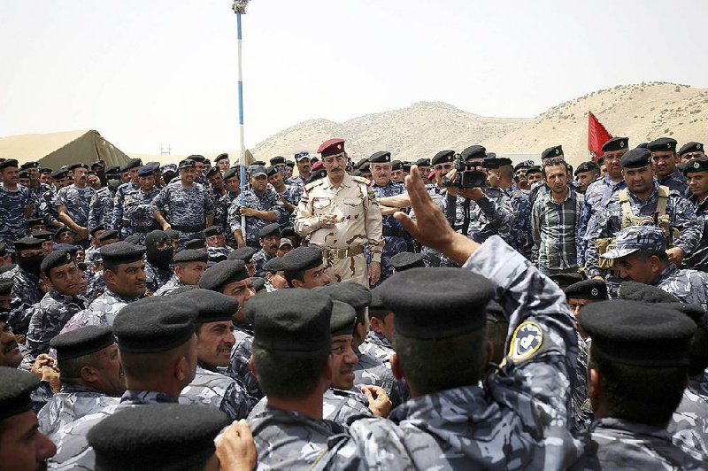 Iraqi Gen. Najim al-Jabouri talks Thursday to police at a camp in Duburdan in northern Iraq, where security forces that fled from Islamic State fighters in Mosul have been receiving training from the U.S. military.