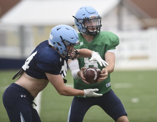 NWA Democrat-Gazette/J.T. Wampler Luke Hannon takes a handoff from quarterback Fuller Chandler during Springdale Har-Ber spring football practice at Wildcat Stadium. Hannon returns after leading the 7A-West in rushing as a junior.