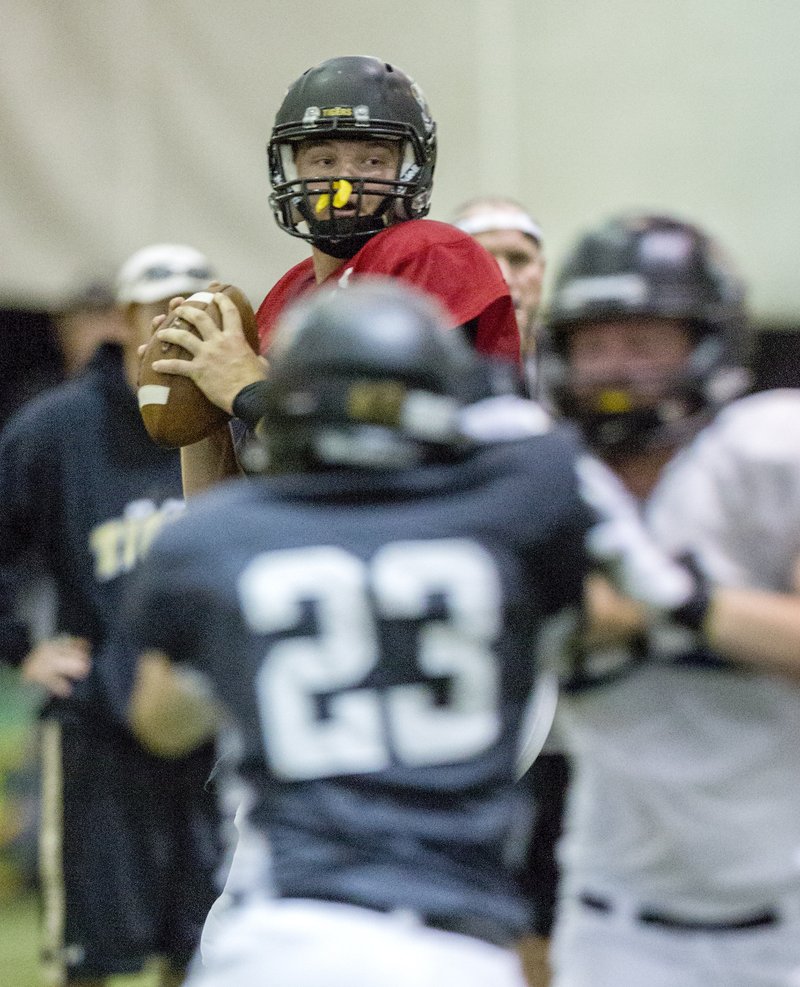 NWA Democrat-Gazette/JASON IVESTER Kasey Ford, Bentonville senior quarterback, drops back to pass Friday during a scrimmage inside the Tiger Athletic Complex.