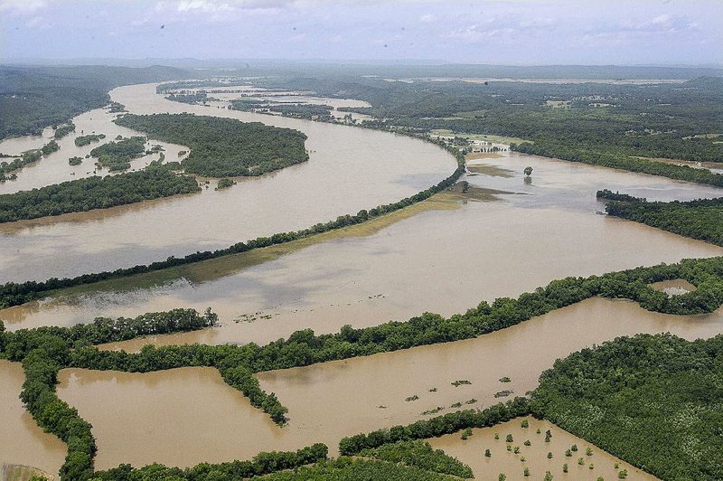 High water spills out of a bend in the Arkansas River channel between North Little Rock and Conway on Friday afternoon. 