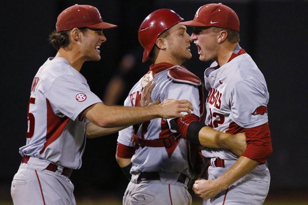 Arkansas' Zach Jackson, right, Tucker Pennell, center, and Jackson Lowery, left, celebrate after Arkansas defeated St. John's in an NCAA college baseball tournament regional game in Stillwater, Okla., Sunday, May 31, 2015. Arkansas won 4-3 and moves on to the super regional. (AP Photo/Sue Ogrocki)