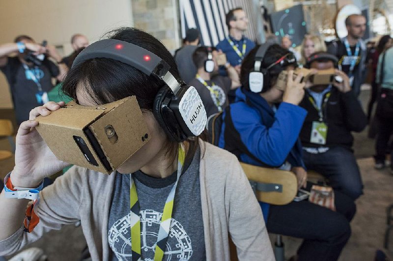 Attendees look through Google Cardboard virtual-reality viewers during the Google I/O Annual Developers Conference in San Francisco last week. 