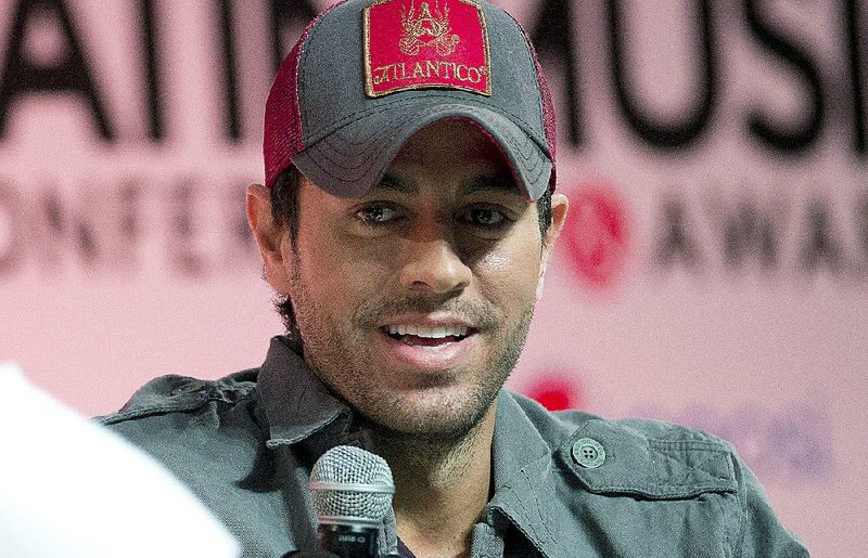 In this April 23, 2014 file photo, Enrique Iglesias talks about his music during a Billboard Latin Music Conference Superstar Q&A session in Miami.  Iglesias is recovering after his fingers were sliced when he grabbed a drone during a concert in Tijuana, Mexico on Saturday, May 31, 2015.