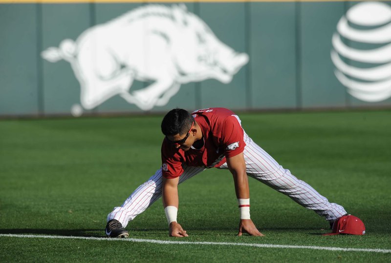 Arkansas infielder Michael Bernal stretches prior to a game against Ole Miss on Friday, March 27, 2015, at Baum Stadium in Fayetteville. 