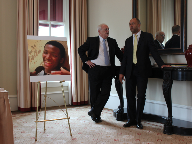 Attorneys Michael Laux, right, Michael A. Kelly stand beside a large photograph of Bobby Moore before a news conference about a federal civil rights lawsuit they filed Monday, June 1, 2015, in Moore's death.