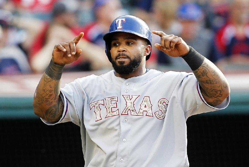 Texas Rangers first baseman Prince Fielder, left, plays with the beard of  shortstop Elvis Andrus as they warm up before facing the Colorado Rockies  in the first inning of a baseball game