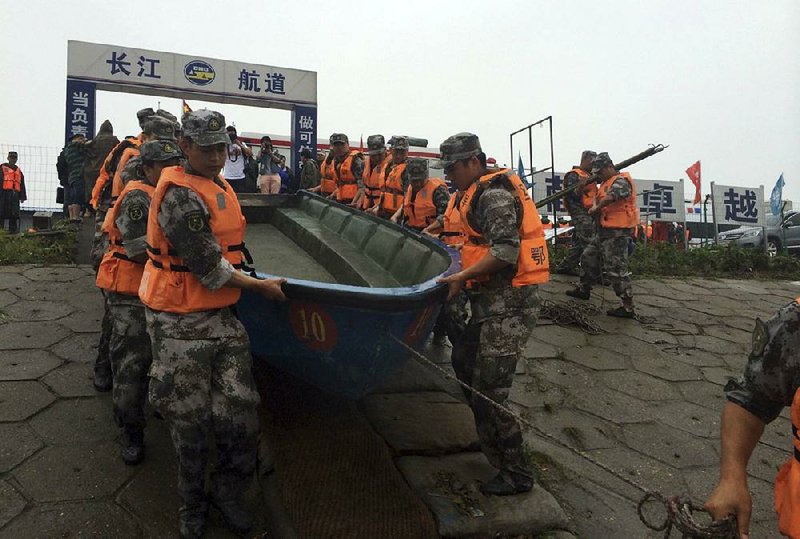 Rescue workers prepare today to search the Yangtze River for passengers and crew after a ship capsized in central China’s Hubei province. The passenger ship carrying more than 450 people sank overnight during a storm, the official Xinhua News Agency reported. 