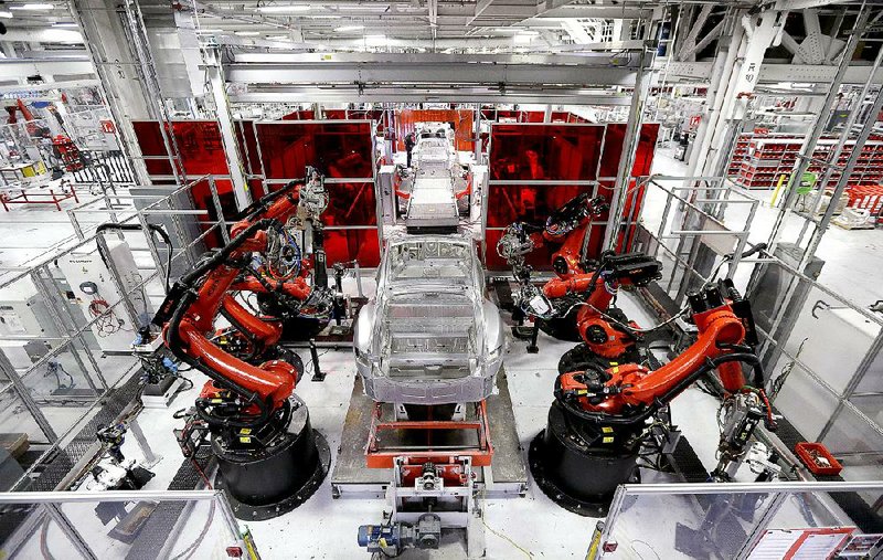 Kuka robots work on Tesla Model S cars in the Tesla factory in Fremont, Calif., in May. A measurement of manufacturing activity in the U.S. rose last month compared with April.