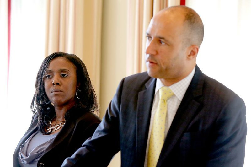 Sylvia Perkins, mother of Bobby Joe Moore III, listens as her attorney Mike Laux answers questions Monday at a news conference. The family filed suit in federal court over the death of Moore, who was fatally shot in 2012 by then-officer Josh Hastings of the Little Rock Police Department. 