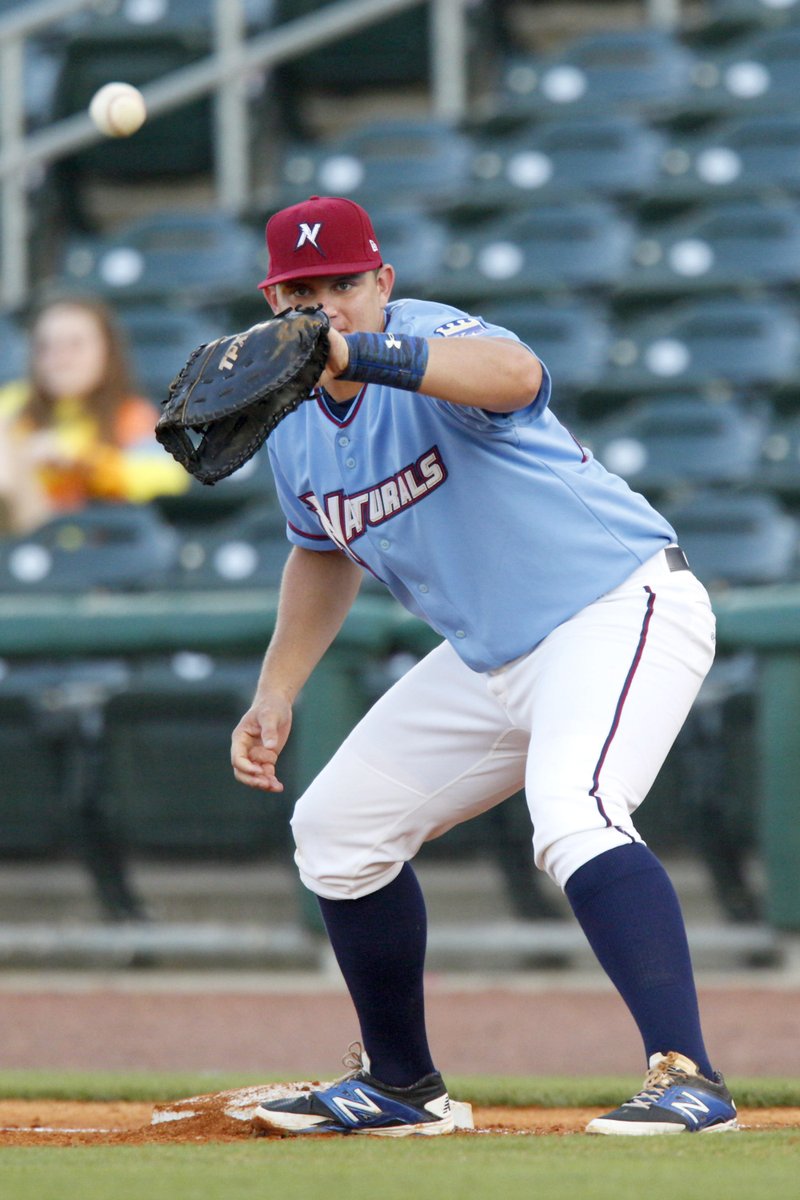 Naturals first baseman Balbino Fuenmayor waits for the throw in a pick-off attempt on May 18 against the Arkansas Travelers at Arvest Ballpark in Springdale.