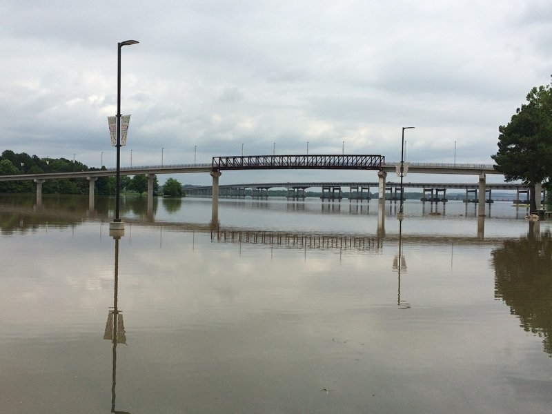 Multiple rounds of heavy rain last month swelled rivers and streams across Arkansas with some still rising this week. This photo shows the flooding in the parking lot at Two Rivers Park in Little Rock on Tuesday, June 2, 2015.
