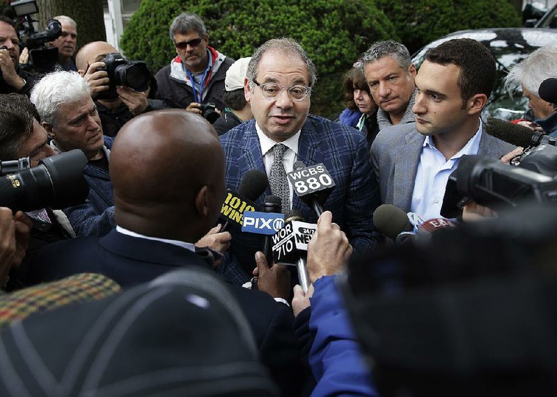 Ahmed Zayat, owner of Triple Crown hopeful American Pharoah, talks to reporters as son Justin (right) looks on Tuesday following Zayat’s arrival at Belmont Park in Elmont, N.Y. 