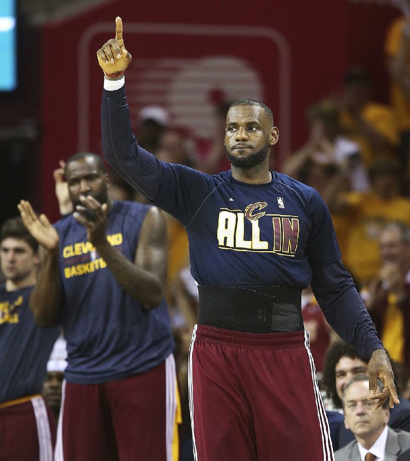 Cleveland Cavaliers forward LeBron James reacts on the sidelines late in the second half of Game 4 of the NBA basketball Eastern Conference Finals against the Atlanta Hawks, Tuesday, May 26, 2015, in Cleveland. 