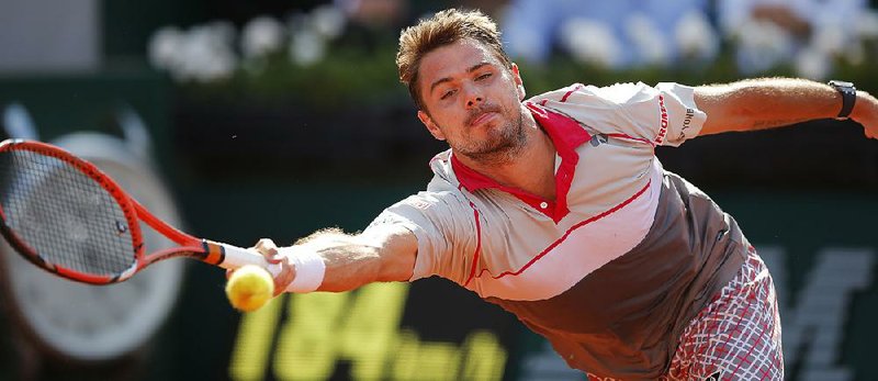 Stan Wawrinka stretches to return a shot to Roger Federer in their quarterfinal match at the French Open in Paris. Wawrinka, the 2014 Australian Open champion, won in straight sets.