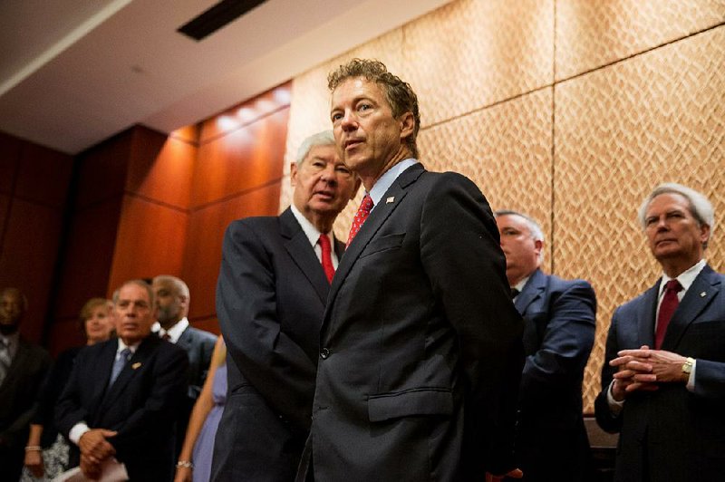 Sen. Rand Paul (front), R-Ky., and former Florida Sen. Bob Graham hold a news conference Tuesday on Capitol Hill about a bill by Paul to make public 28 redacted pages of the 9/11 Commission report. Paul led opposition to the surveillance bill approved by the Senate.