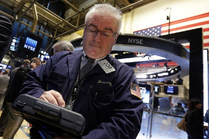 Trader James Dresch works Tuesday on the floor of the New York Stock Exchange.