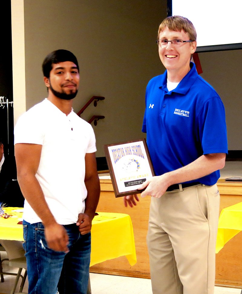 Photo by Mike Eckels Allan Castaneda (left) receives the male Athlete of the Year award from John Unger, Decatur athletic director, during the 2015 Decatur Athletic Banquet held on May 2.