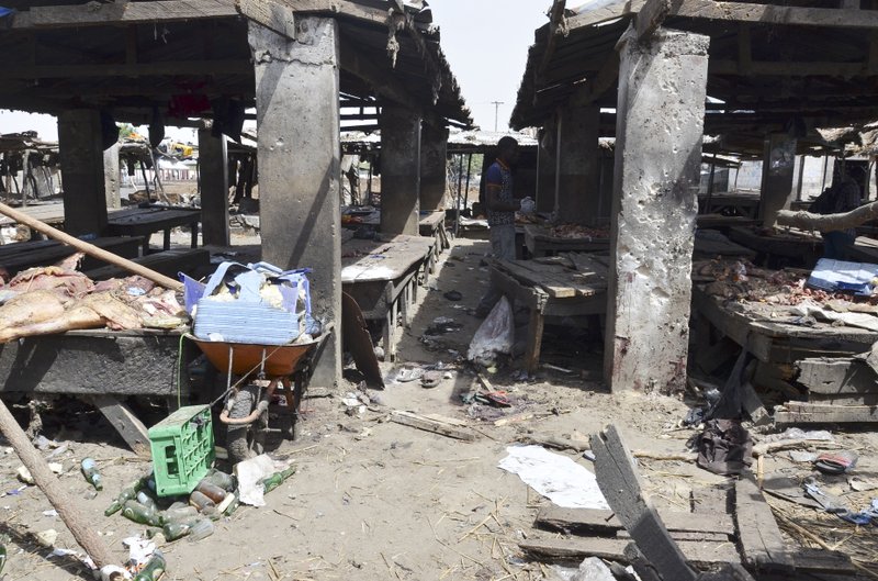 A man  inspects the  site of  a suicide bomb attack at a market in Maiduguri , Nigeria, Tuesday, June 2, 2015.  Boko Haram attacked the northeastern Nigerian city of Maiduguri on Tuesday with deafening explosions from the west and a suicide bombing near the center that witnesses said killed as many as 20 people. 