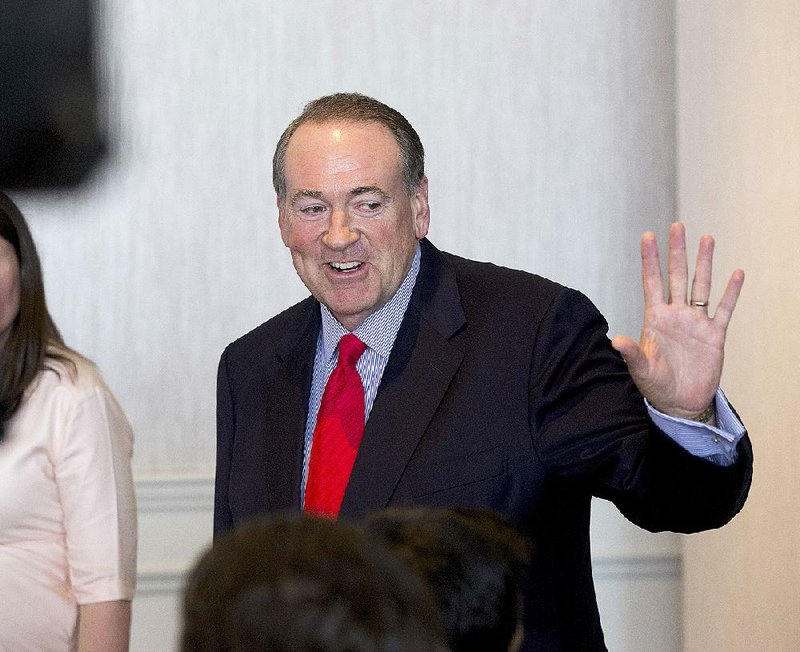 Mike Huckabee, the former Arkansas governor and 2016 Republican presidential candidate, waves goodbye to reporters Wednesday afternoon after a Little Rock press conference. Huckabee was in town for a fundraiser.