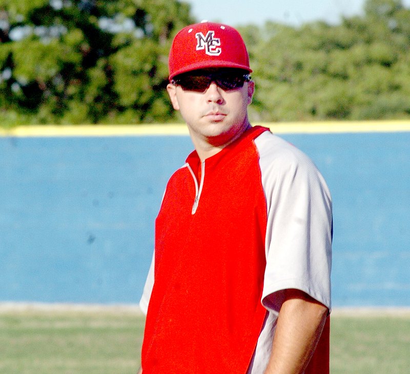 RICK PECK MCDONALD COUNTY PRESS Skyler Rawlins coaches first base for the McDonald County Mustang baseball team during the recent district tournament. Rawlins will take over as head coach of the Lady Mustang softball team this fall.