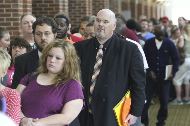 In this April 2, 2015, photo, David Dunn from Chickamauga, Ga., right, stands in line with hundreds of other job seekers at The Colonnade in Ringgold, Ga., to attend a huge 15-county job fair. Payroll processor ADP reports how many jobs private employers added in May on Wednesday, June 3, 2015.