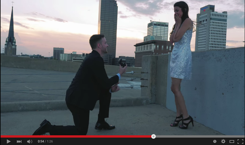 This screenshot from a Seth McMurry and Cymber Browder's engagement video shows the moment he got down on one knee and proposed. Watch the full video below.