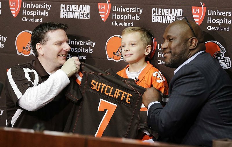 Dylan Sutcliffe (middle), a 9-year-old from Lyndhurst, Ohio, signed a one-day contract with the Cleveland Browns on Tuesday, thanks to the Make-A-Wish Foundation.