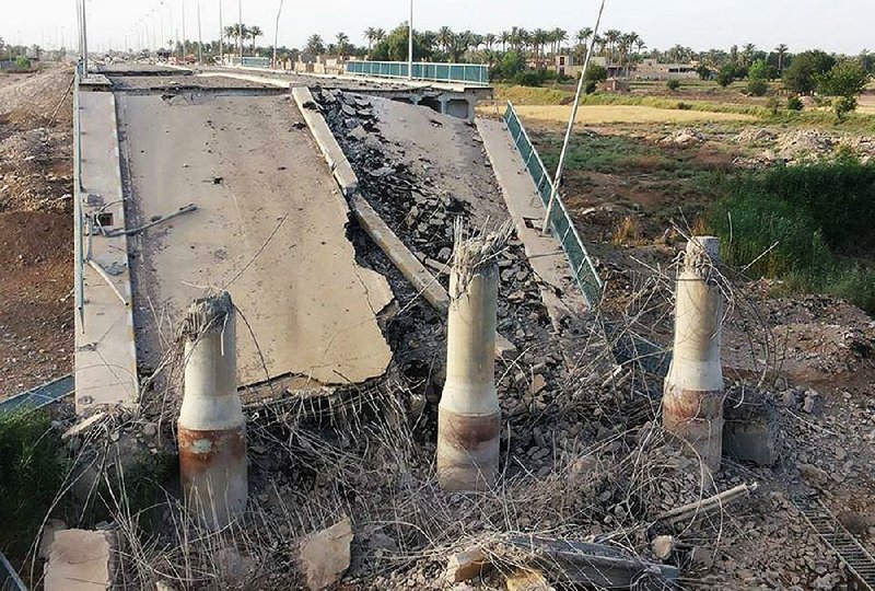 The Islamic State group used a car bomb to destroy a bridge on the Euphrates River to cut the northern entrance into Ramadi, Iraqis said. The militants captured Ramadi last month.